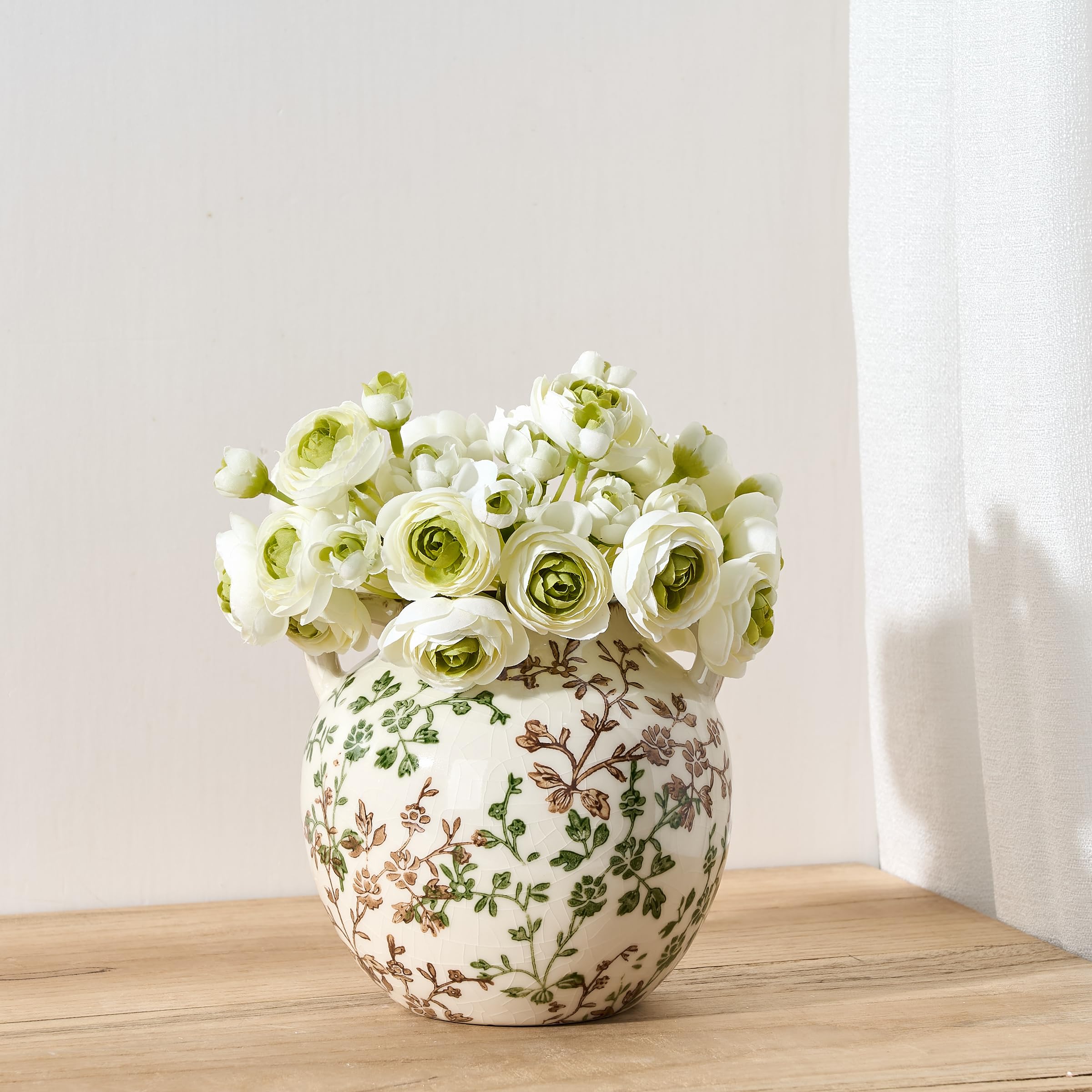 PORCER vintage chinoiserie vase pairs with greenery on a table.