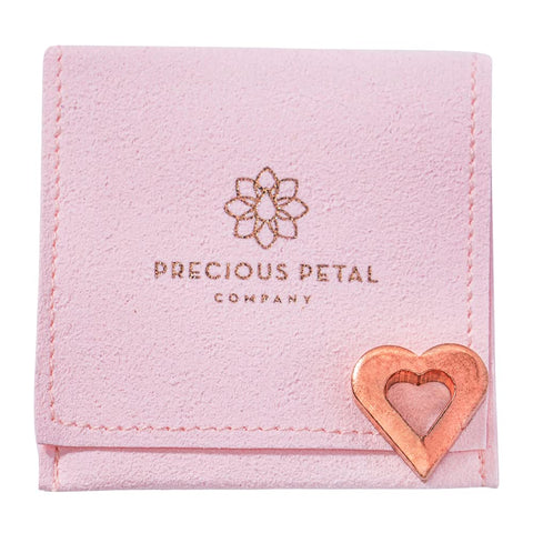 Copper charm with micro suede bag from Precious Petal Co for safe storage.