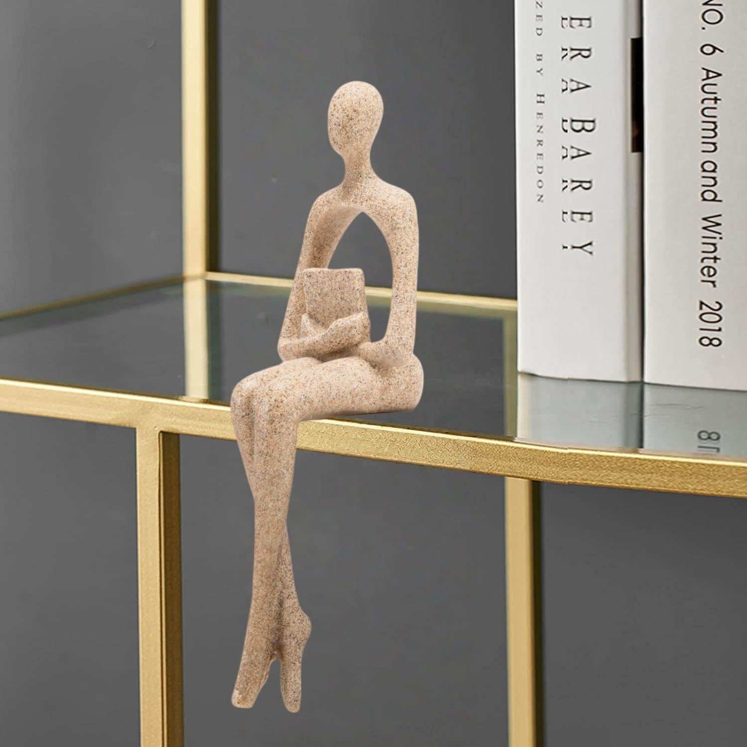 Gold resin thinker sculptures add luxury to living room