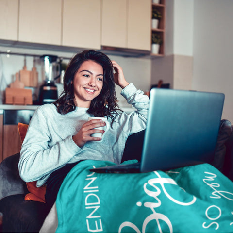 Pubrave teal hug blanket on couch offers comforting relaxation.