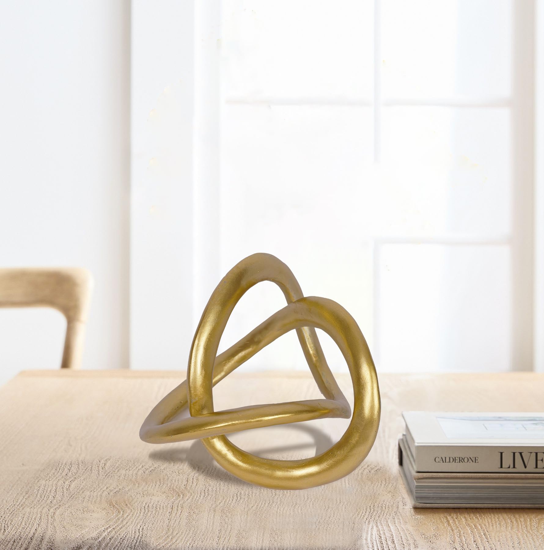 PUHOZN gold knot statue serves as a focal point in living room decor.