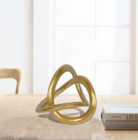 PUHOZN gold knot statue serves as a focal point in living room decor.