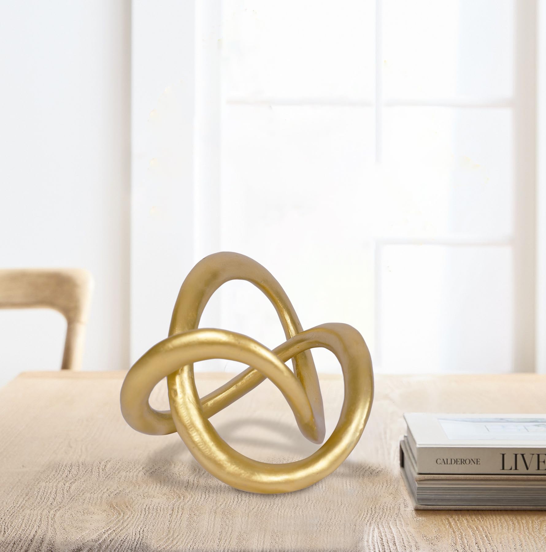 PUHOZN knot artwork complements mantel and bookshelves with refined shine.