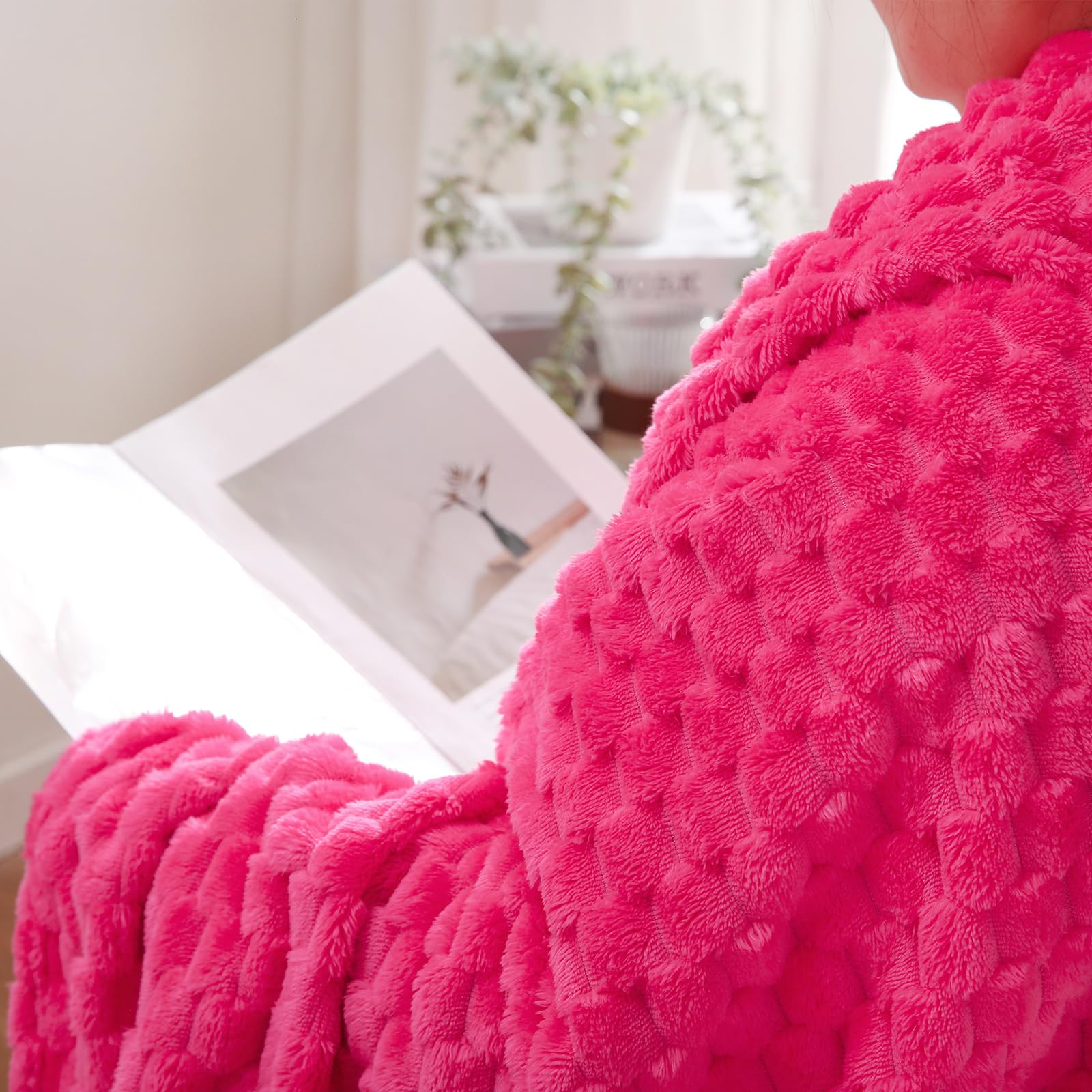 Puncuntex hot pink throw folded on chair for quick warmth.