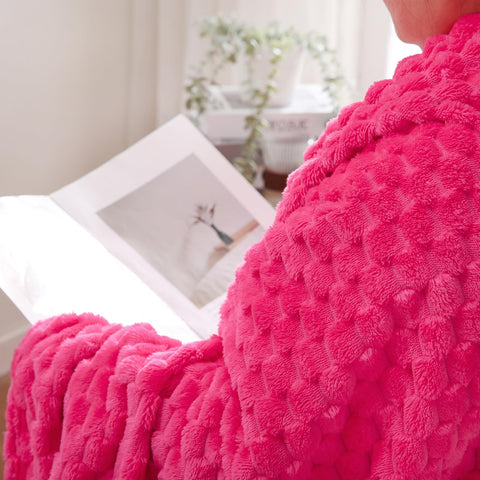 Puncuntex hot pink throw folded on chair for quick warmth.