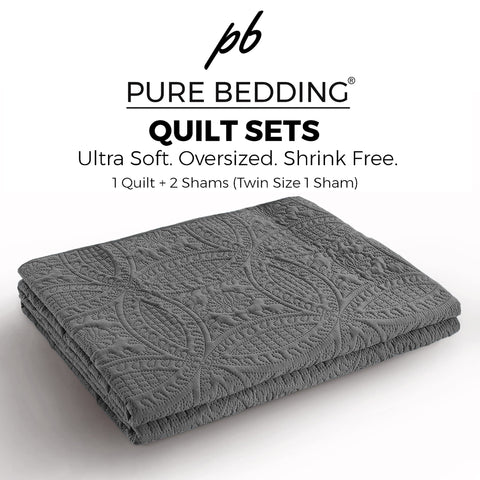 Pure Bedding quilt on bed in a neutral room demonstrates versatile all-season wear.