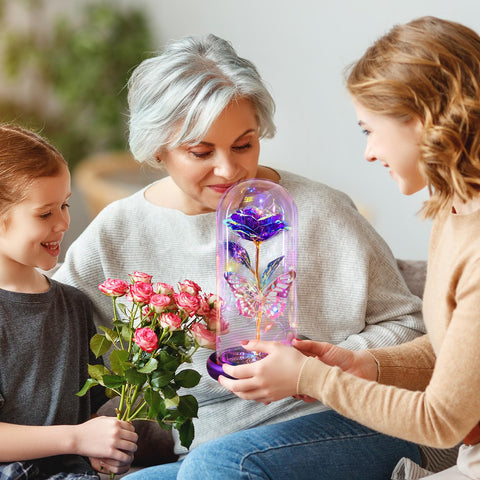 Pusuny butterfly-decor rose in glass dome brightens a nightstand.