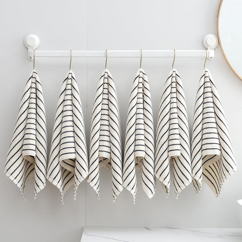 Qaxopl stripe towels in a basket convey ready-to-use organization for bathrooms and guest rooms.