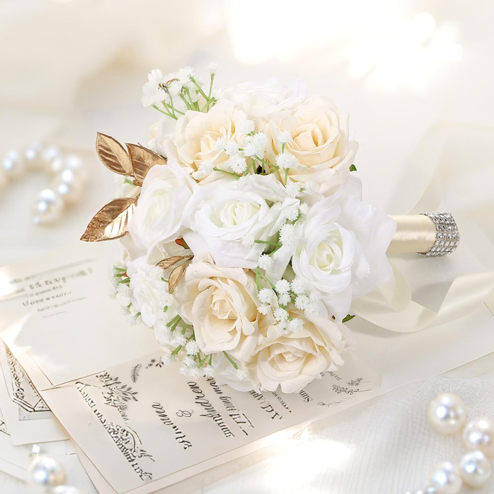 Qeedy bride bouquet shows satin-wrapped handle and rhinestones for a sparkle touch.
