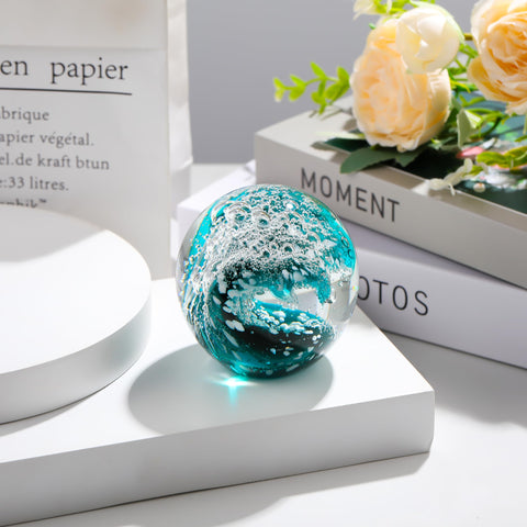Qianwei crystal ball on a desk adds shimmer for office decor.