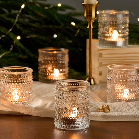 Qipecedm clear glass tealight holder on dining tables for festive celebrations.