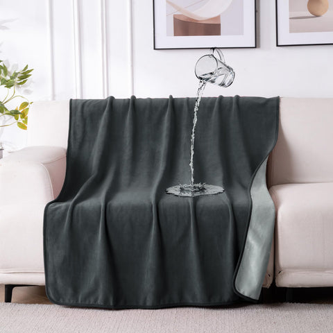 QiyI waterproof blanket on bed shows dual-tone design and spill protection.