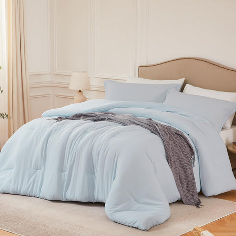 Quataly Queen SkyBlue comforter set on bed for all-season coziness.