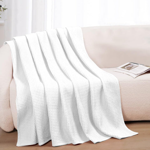 QUBA LINEN soft-touch waffle blanket emphasizes gentle, cozy feel; ideal for lounging.