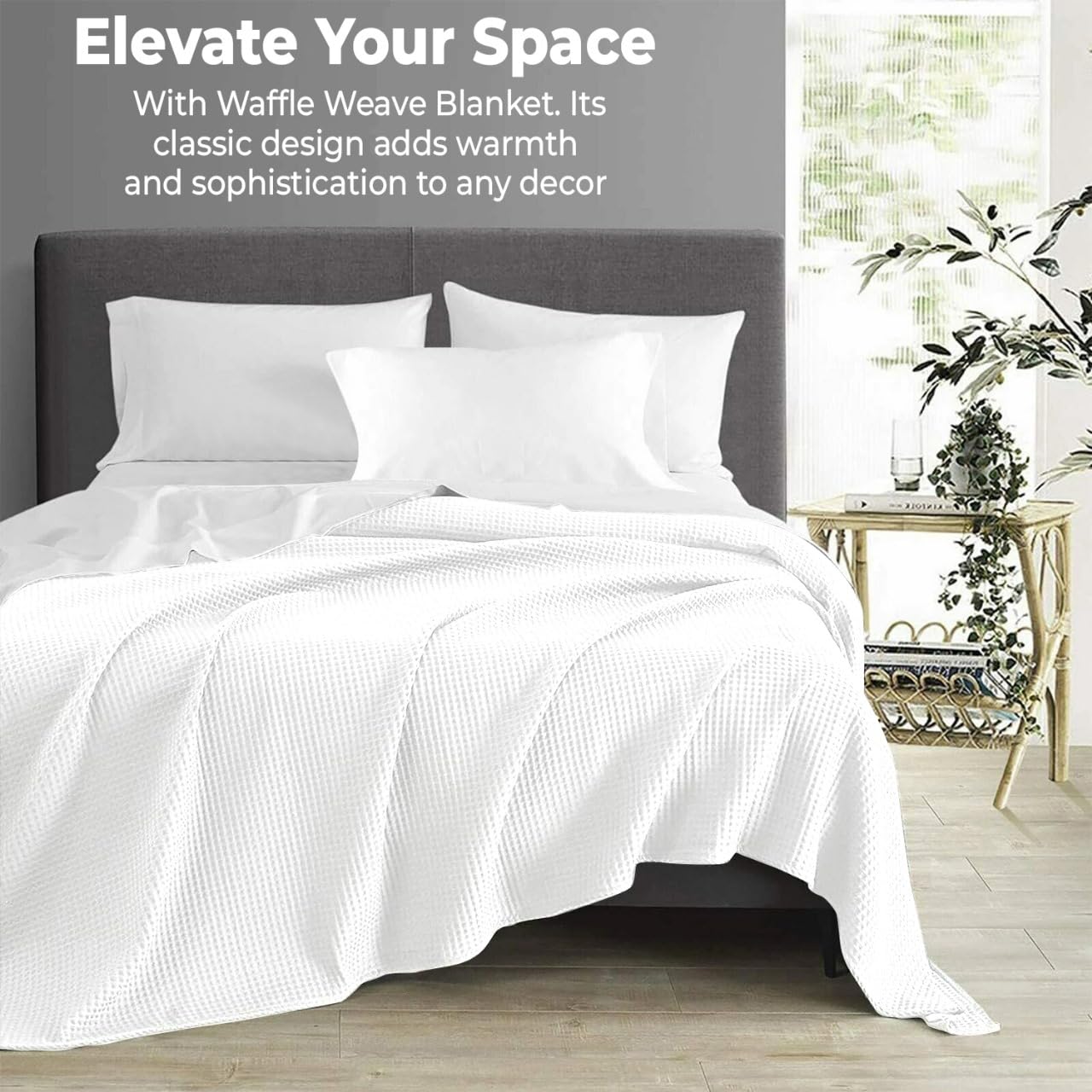 QUBA LINEN waffle blanket on bed draped in white for easy elegance.