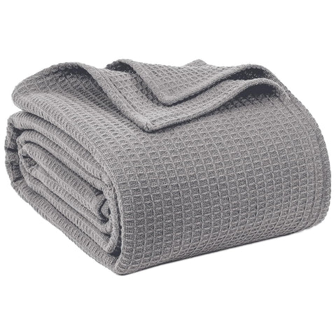 QUBA LINEN waffle blanket on a bed for lightweight summer comfort