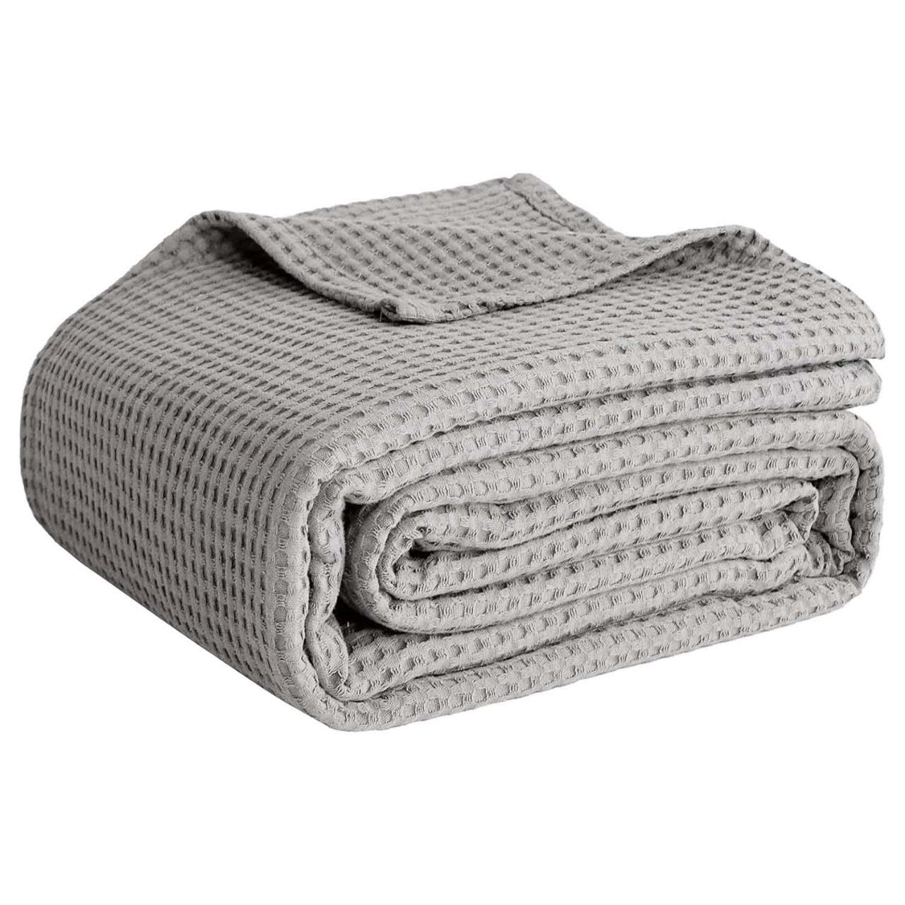 QUBA LINEN waffle weave blanket for warm, breathable comfort on bed or sofa.