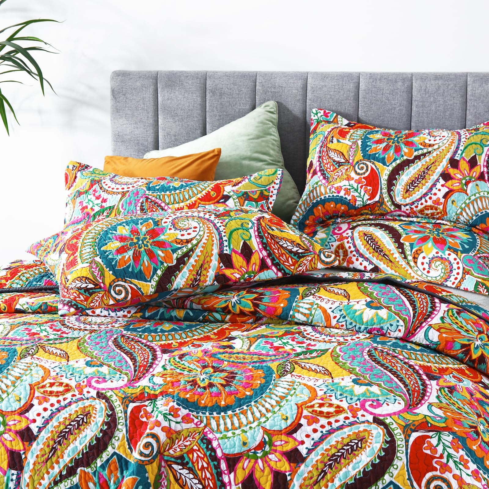 Qucover California king quilt in vibrant colors brightens a room.