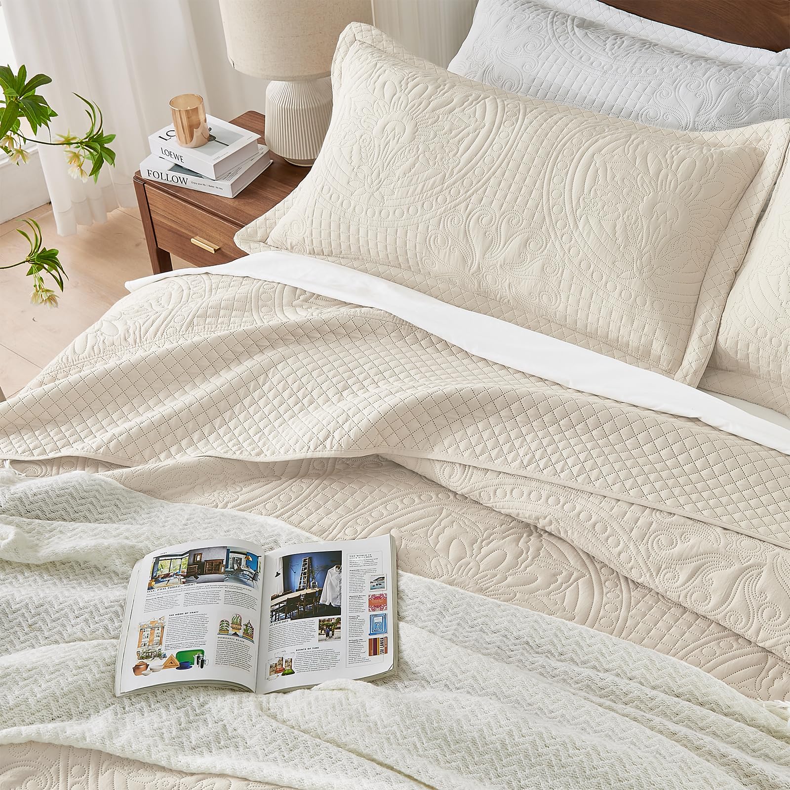 Qucover oversized king bedspread in beige styled bedroom scene showing floor-to-bed coverage.