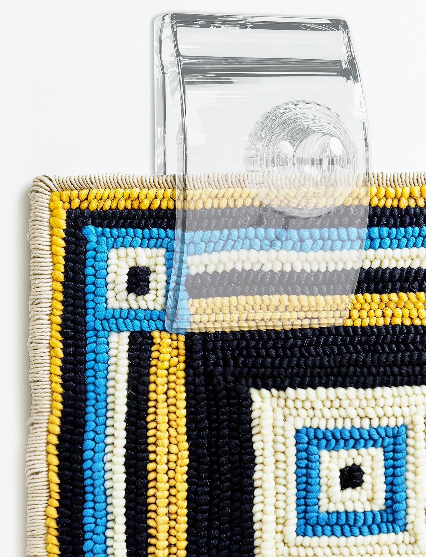 Quiltera tapestry hangers on wall display quilts clearly with unobtrusive clips.