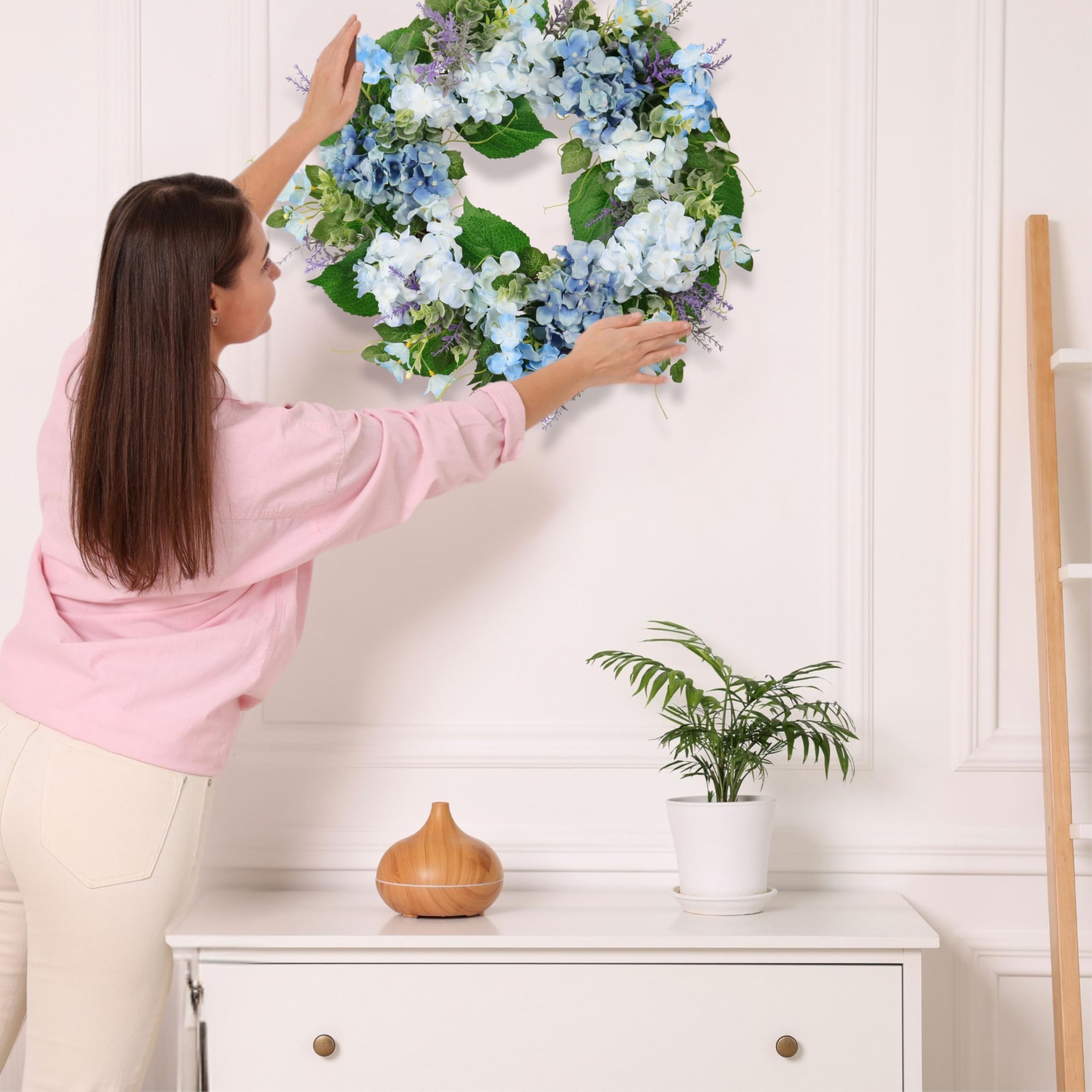 Quixem baby's breath accents add delicate, airy detail to the wreath.