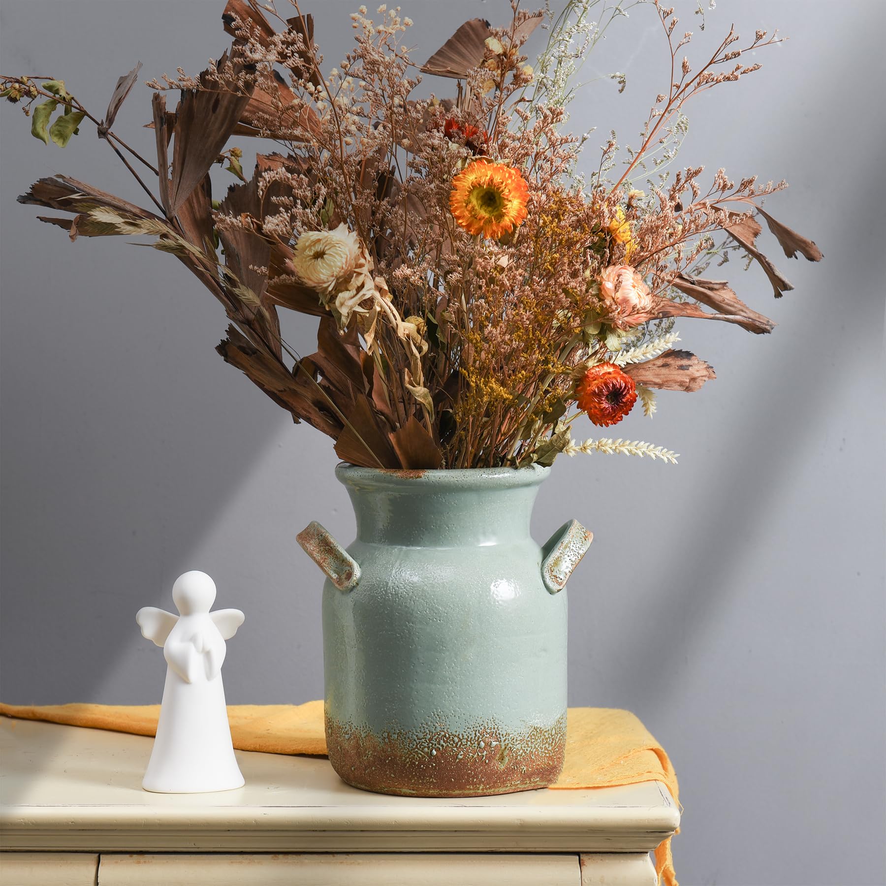Quoowiit rustic vase used as a versatile centerpiece on shelves or mantels.