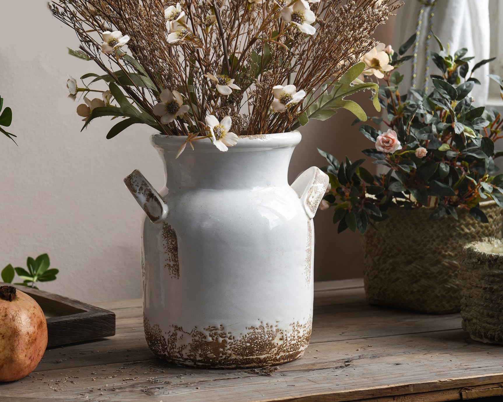 Quoowiit white boho vase styled with greenery for living room ambiance.