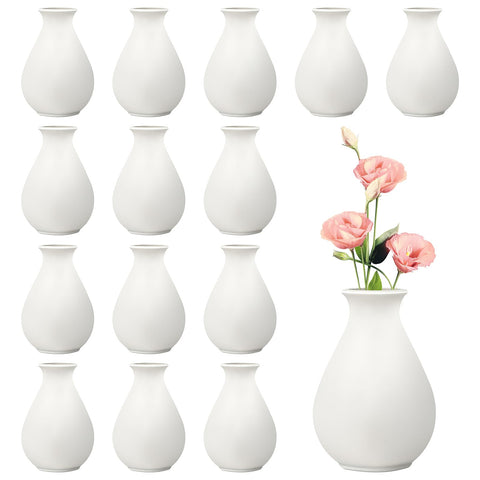 Rainmae 15-pack white ceramic bud vases on a table, ideal for stylish centerpieces.