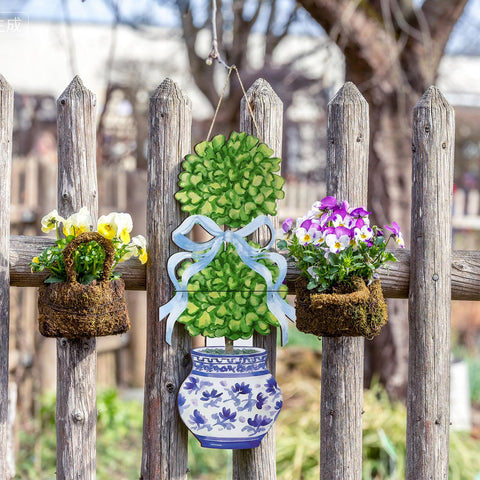 RattanView bonsai door hanger hanging on door, ideal for porch display.