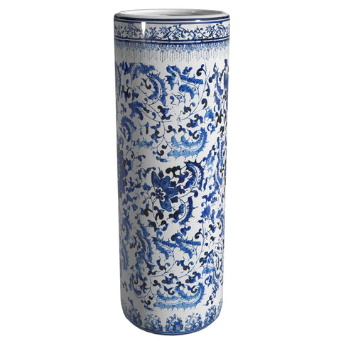 Red Lantern entryway display with porcelain stand under soft lighting.