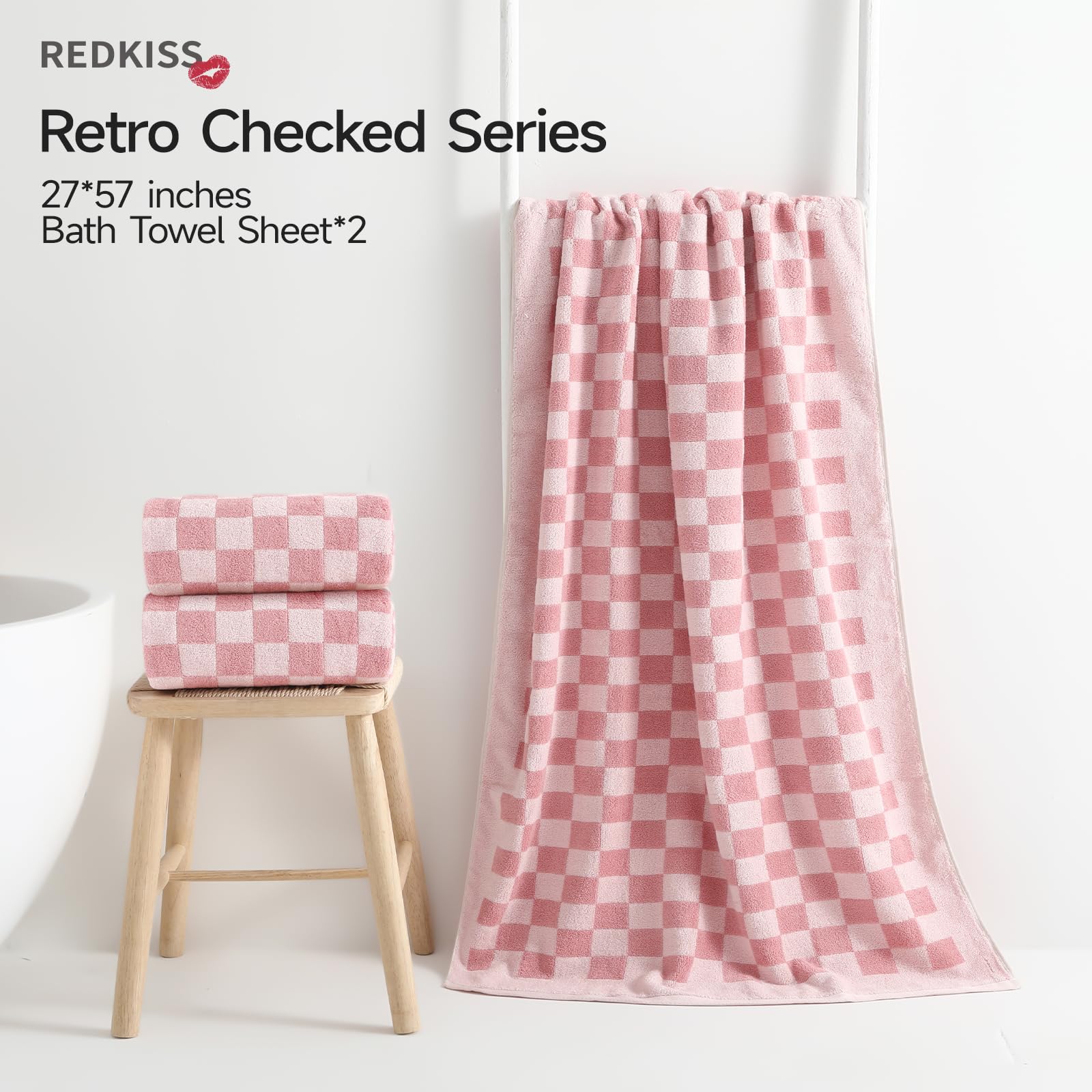 REDKISS pink checkered towels on a rack, offering hotel-level softness and quick-dry comfort.