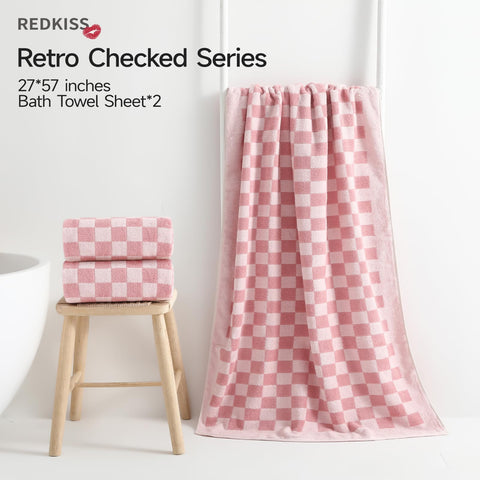 REDKISS pink checkered towels on a rack, offering hotel-level softness and quick-dry comfort.