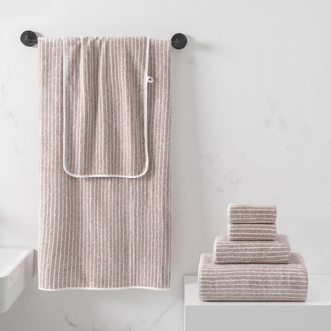 REDKISS taupe bath towels close-up showing plush texture for quick comforting wraps.