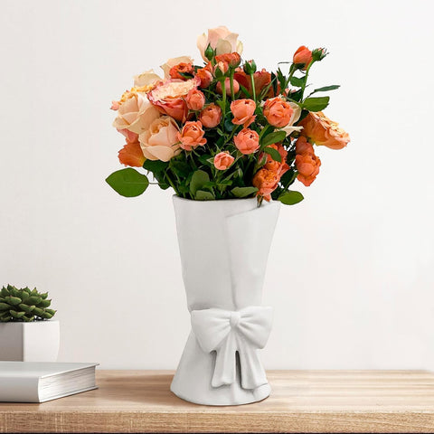 Relexome white ceramic bow vase for stylish bouquets.