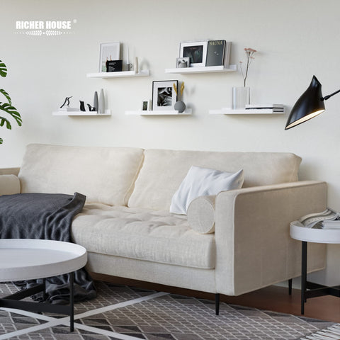 RICHER HOUSE gallery-style shelf arrangement creates balanced wall art in living spaces.