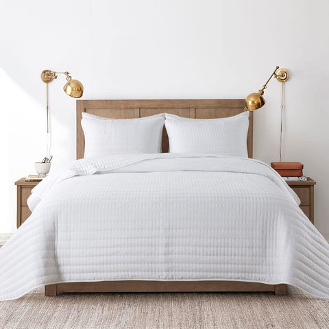 ROARINGWILD cal king quilt on bed, white lightweight coverlet for year-round use.