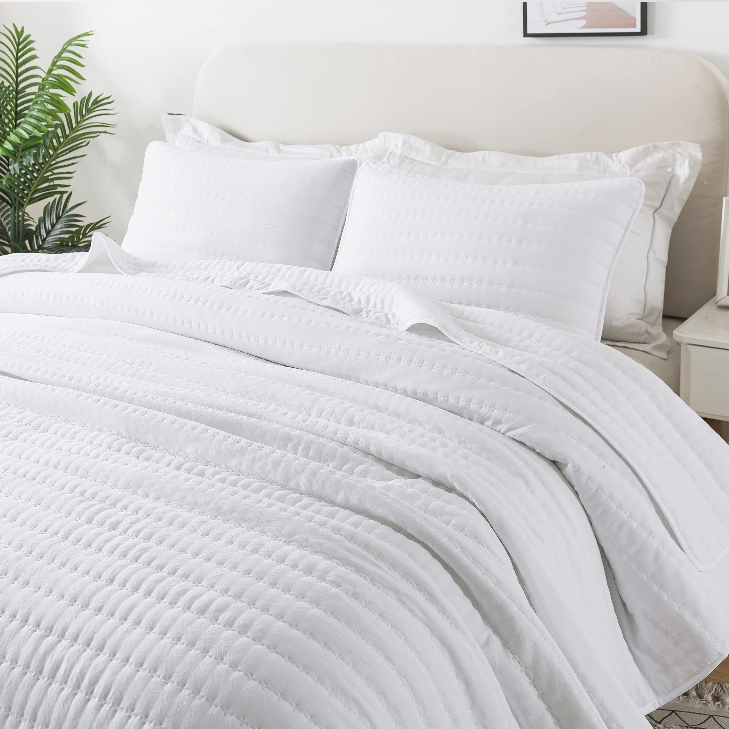 ROARINGWILD white king-size quilt bedspread on bed for all-season comfort.