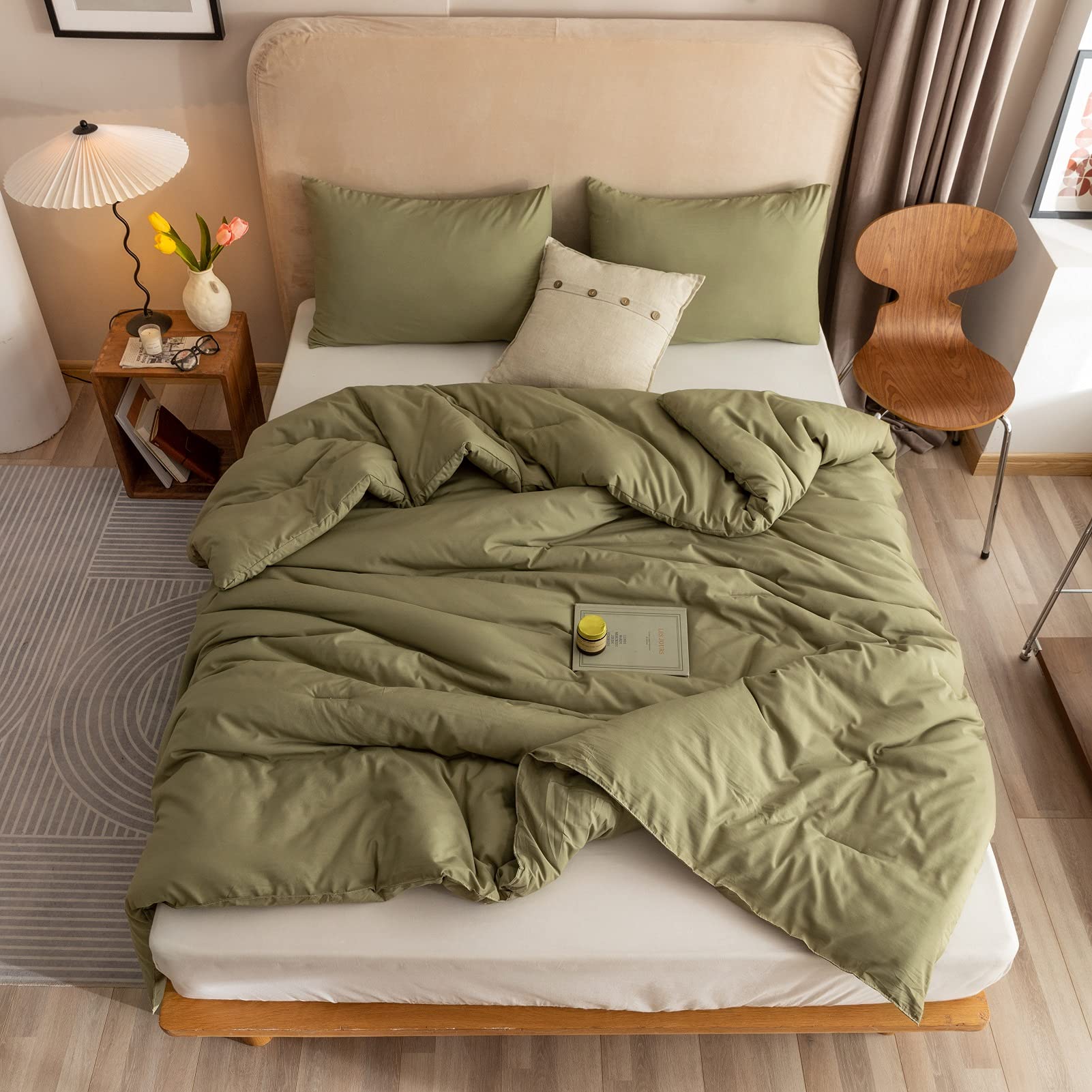 ROSGONIA olive green comforter folded neatly on a bed
