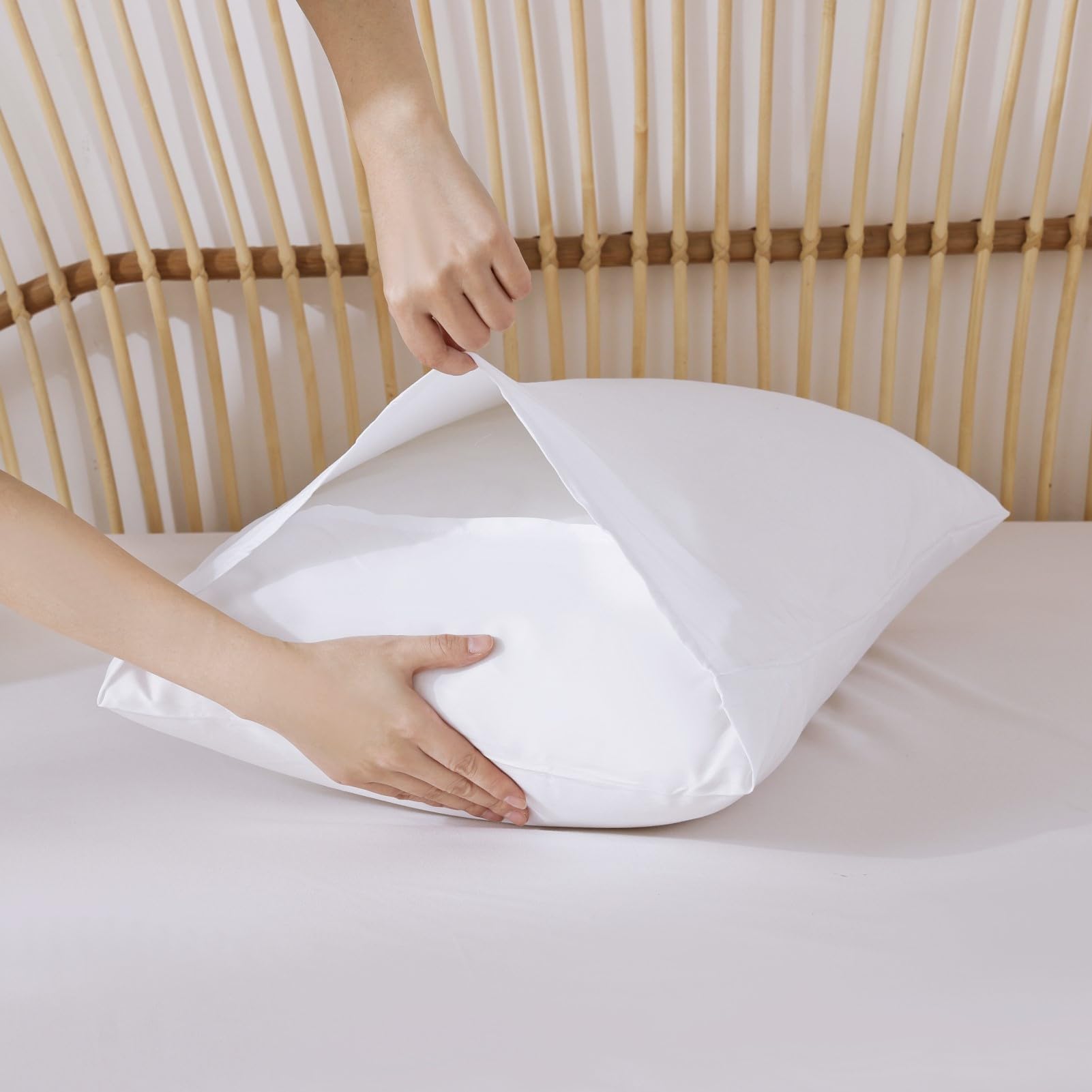 ROSGONIA pillowcase pair complements white bedding with simple, clean lines.