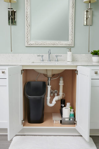 Black waste bin complements bathrooms or offices with discreet storage.