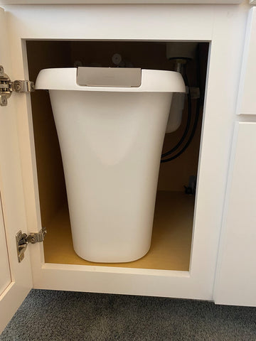 Rubbermaid open-top trash can white bathroom setup example