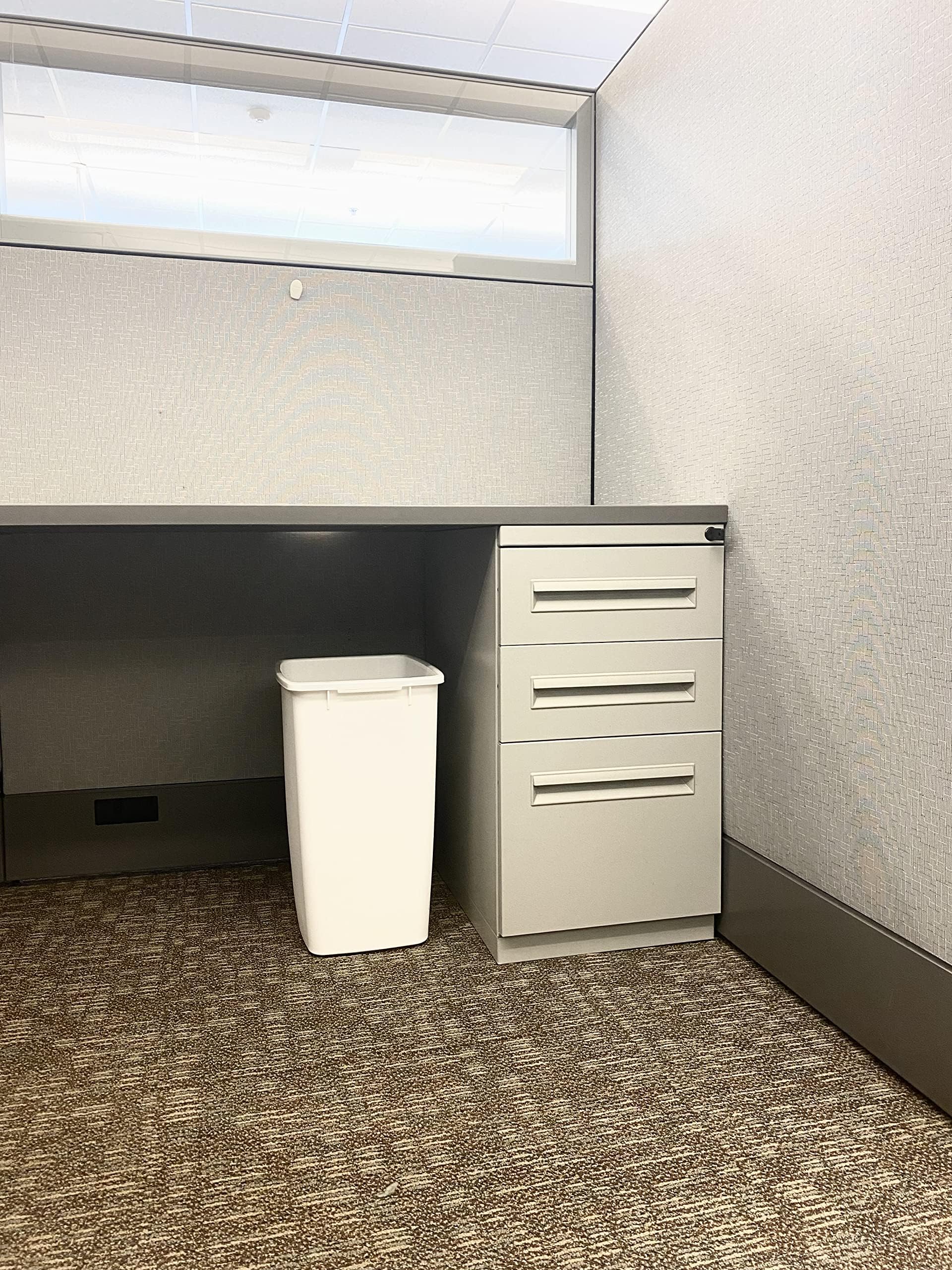 Rubbermaid white under-sink trash bin angled view, great for compact kitchen spaces.