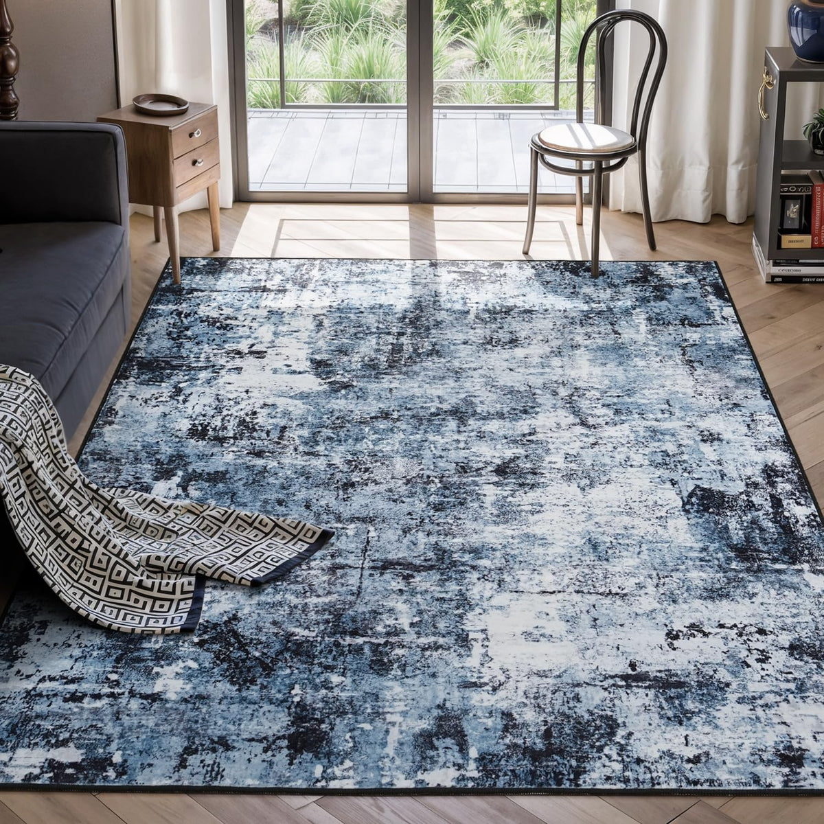 Rugflix 5x7 abstract navy-black rug in a living room for refined style and stain concealment.