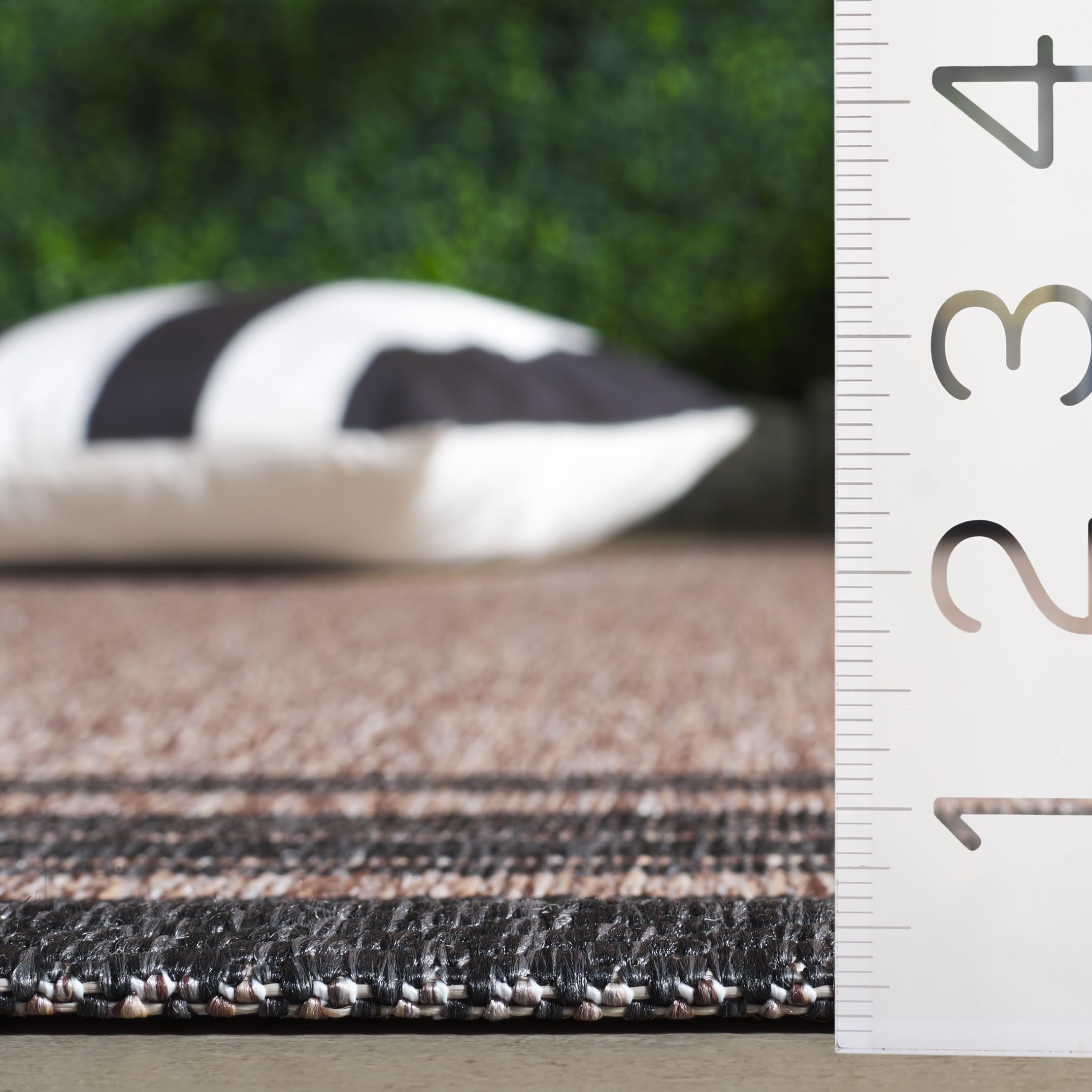 Safavieh Courtyard rug on deck highlights kid- and pet-friendly practicality.