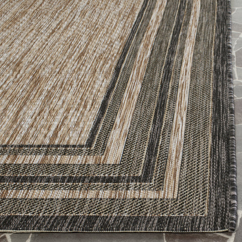 SAFAVIEH Courtyard natural-black outdoor rug highlighting patio or mudroom use.