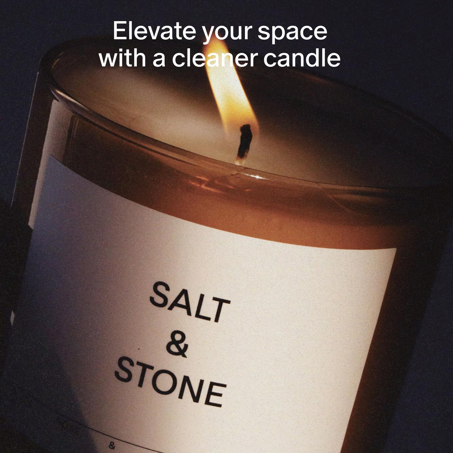 Salt & Stone candle lit close-up showing cotton wick and wax texture for mood setting.