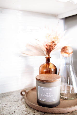 Sand + Fog candle in bathroom creates calming ambiance.