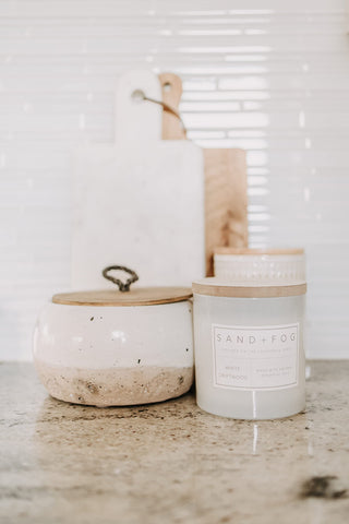 Sand + Fog candle in kitchen setting adds inviting aroma.