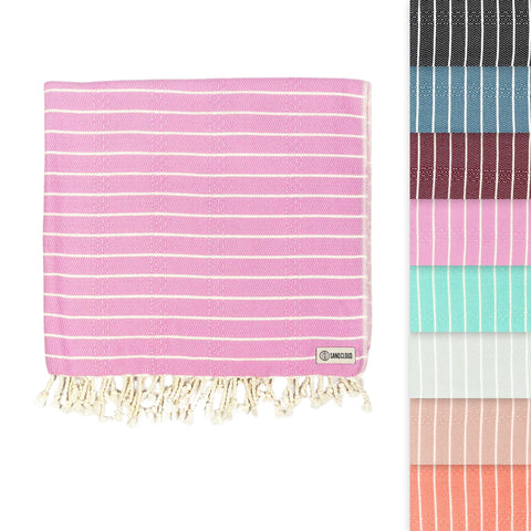 Sand Cloud Gocek Pink Turkish Beach Towel on sandy beach for comfortable sun days.