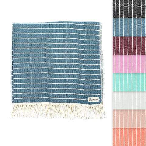 Sand Cloud Turkish Beach Towel Gocek Denim on sand, a portable, sand-resistant beach scene.